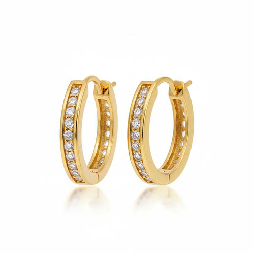 A pair of gold hoop earrings with rows of clear pavé-set stones, shown on a clean white background with a soft reflection below.