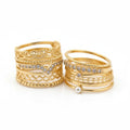 Set of gold rings with various designs on a white background