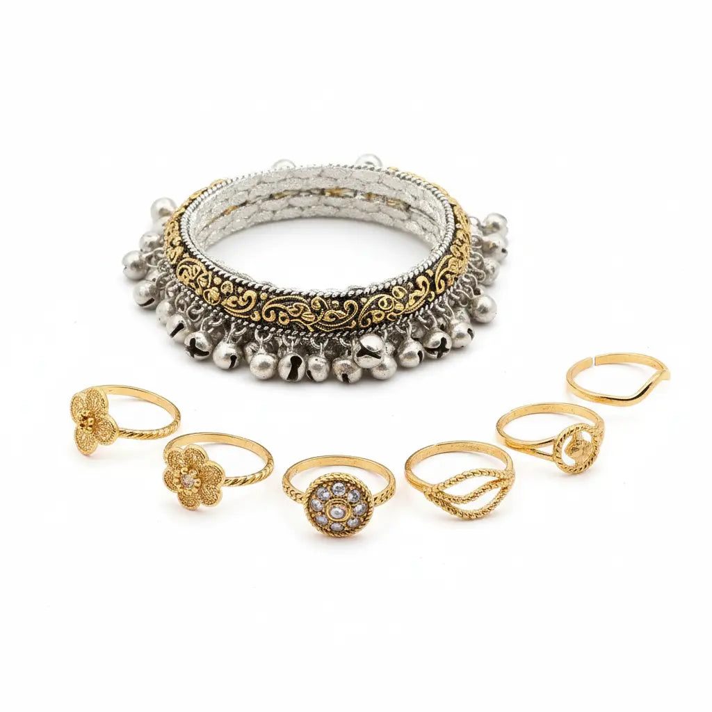 Set of gold and silver bangles and rings on a white background