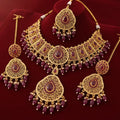 Gold and red gemstone jewelry set on a red background