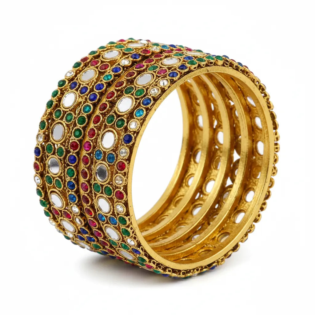 Gold bangles with colorful gemstones on a white background